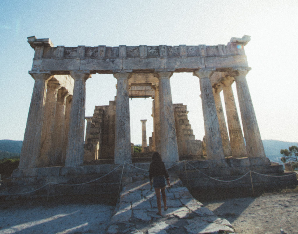 woman approaching an ancient Greek temple at the Acropolis, Greece
