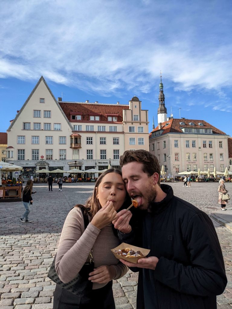 man and woman sharing dessert in a square