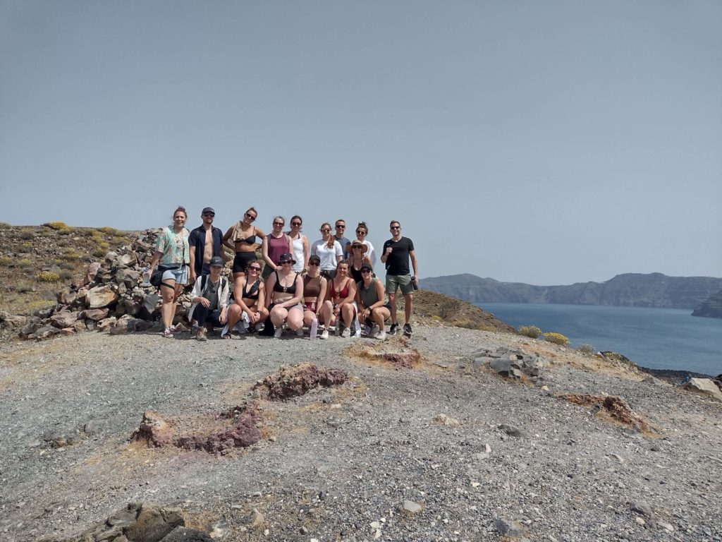 group of travellers on top of Santorini Volcano