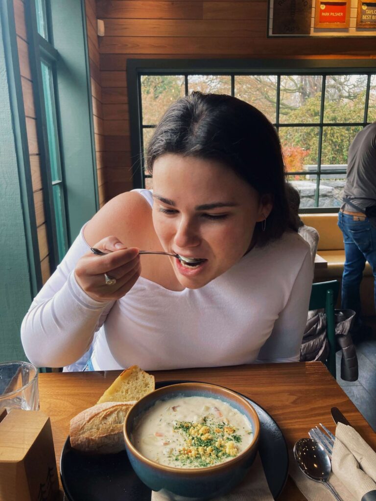Young woman eating clam chowder in Vancouver
