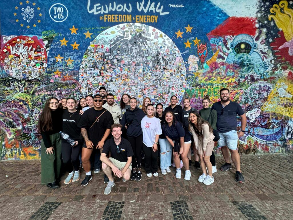 Travellers posing by the Lennon Wall in Prague on a Get Social: Central & Eastern Europe tour.