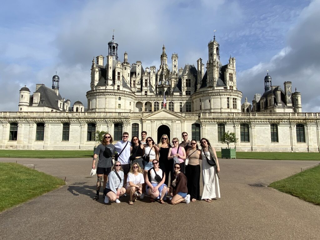 Group of young travellers outside grand building