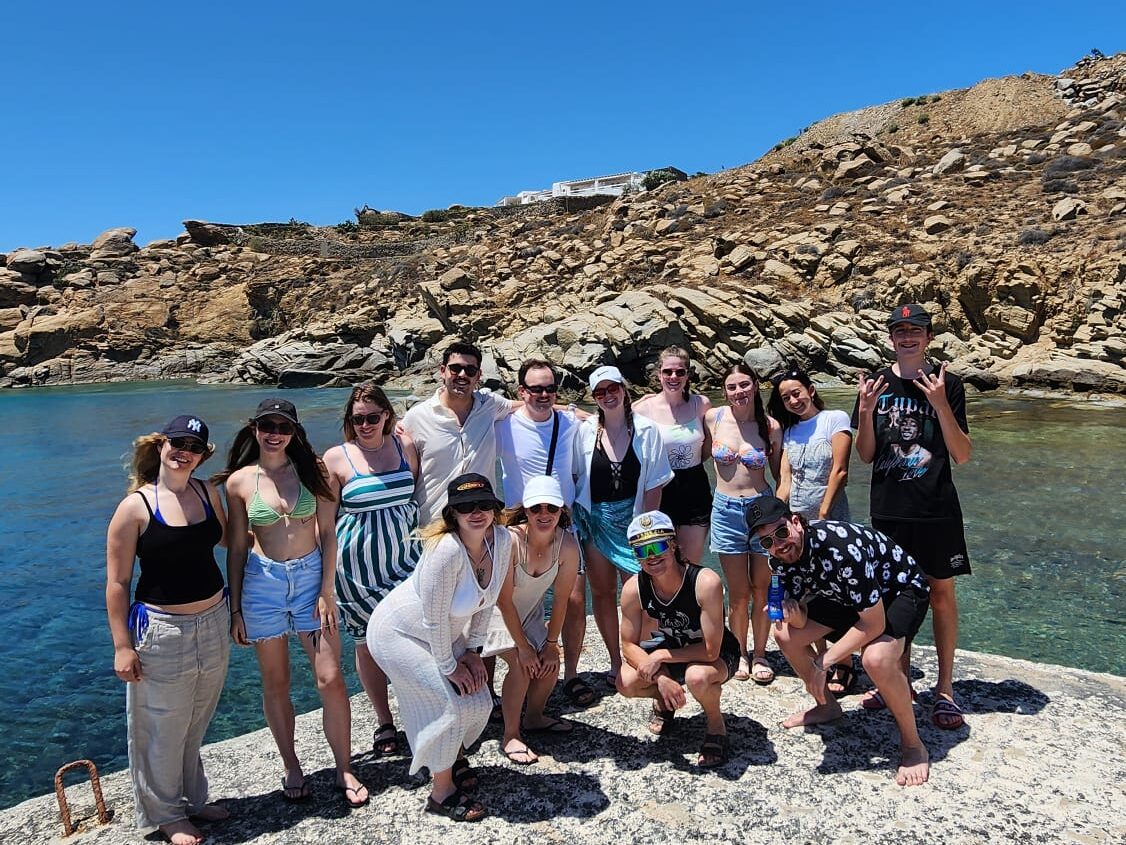 Group of travellers in sunshine by the sea