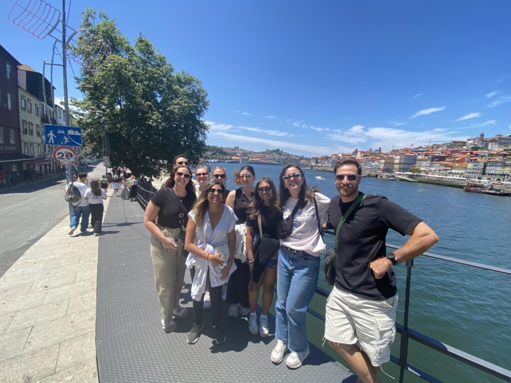 Group of travellers posing next to river