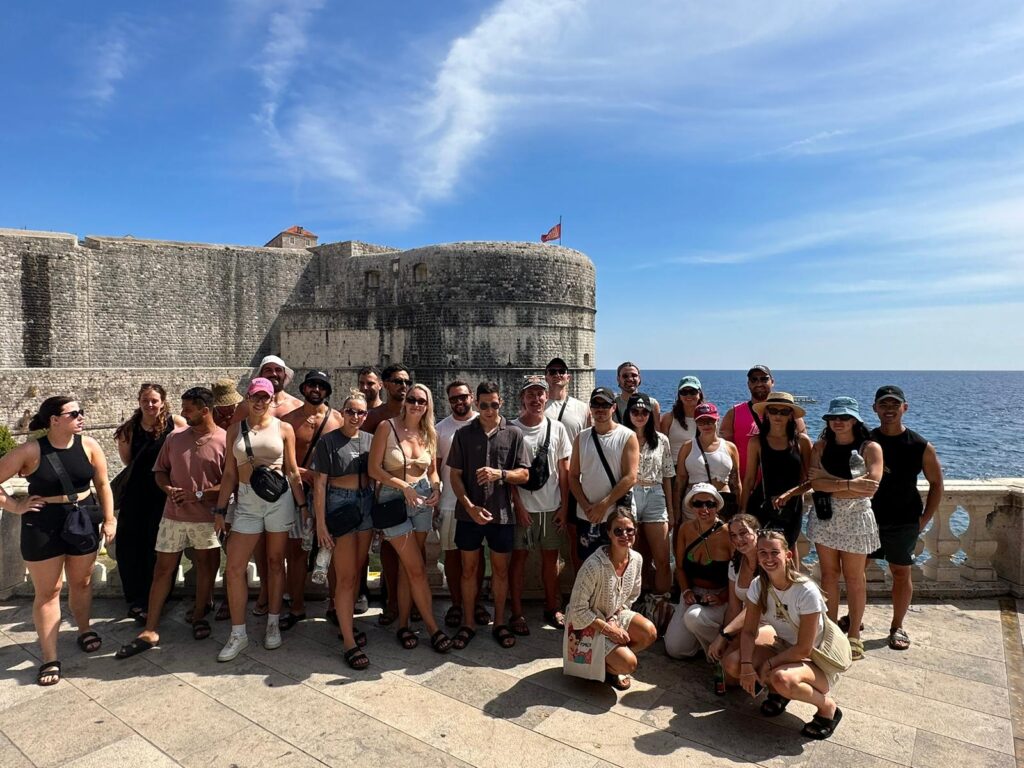 Group of people posing by the City Walls of Dubrovnik 