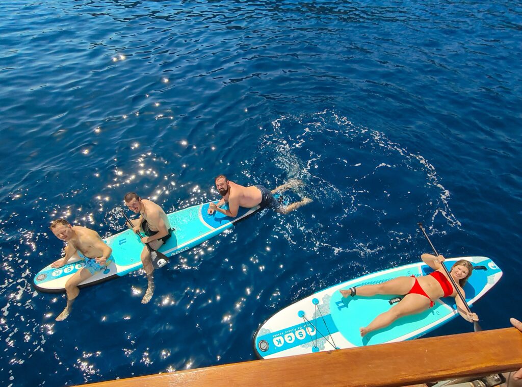 A group of people on paddleboards in the sea in Greece