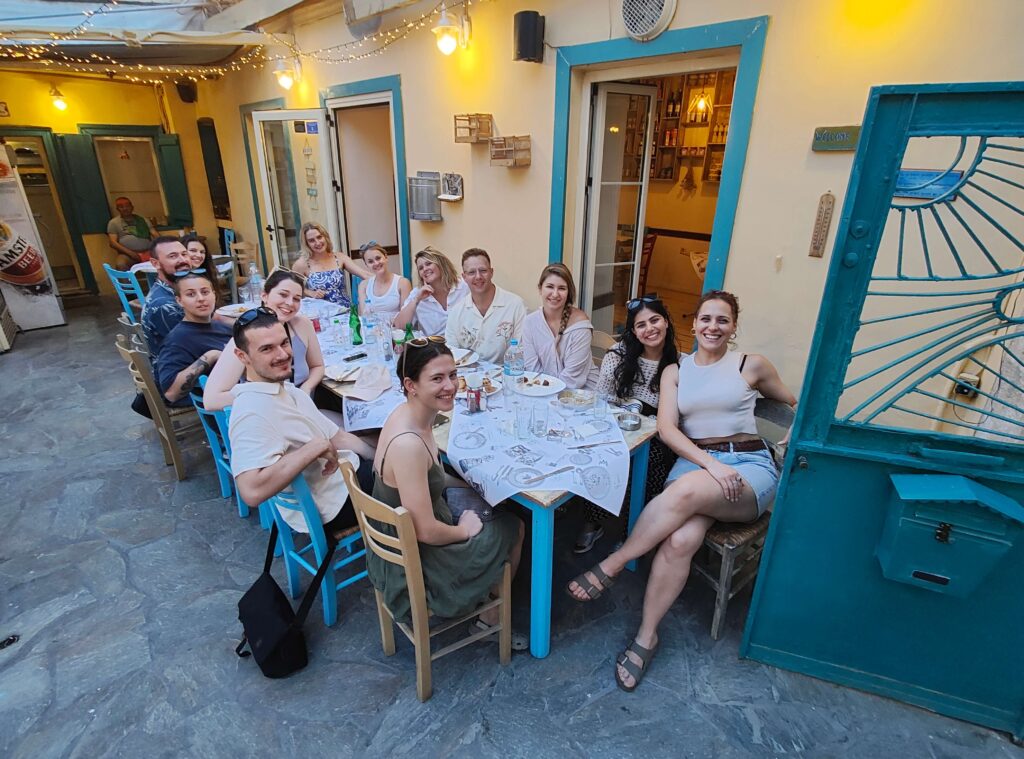 Group of people having dinner in a restaurant in Greece