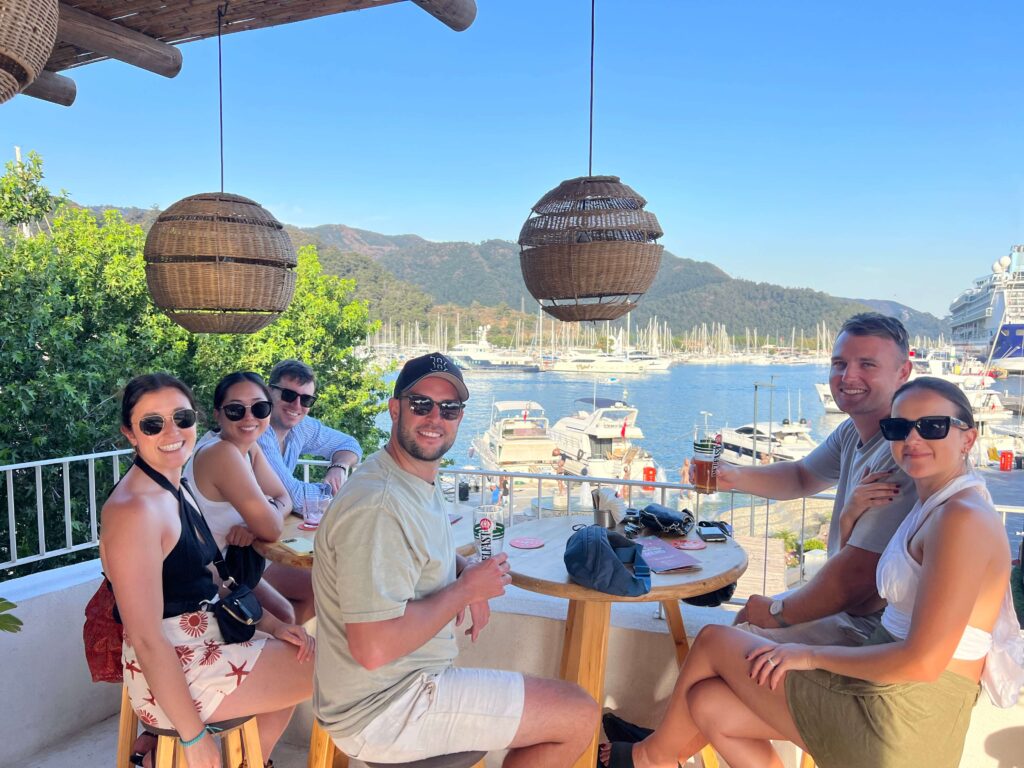 Group of people having drinks overlooking a port in Turkey