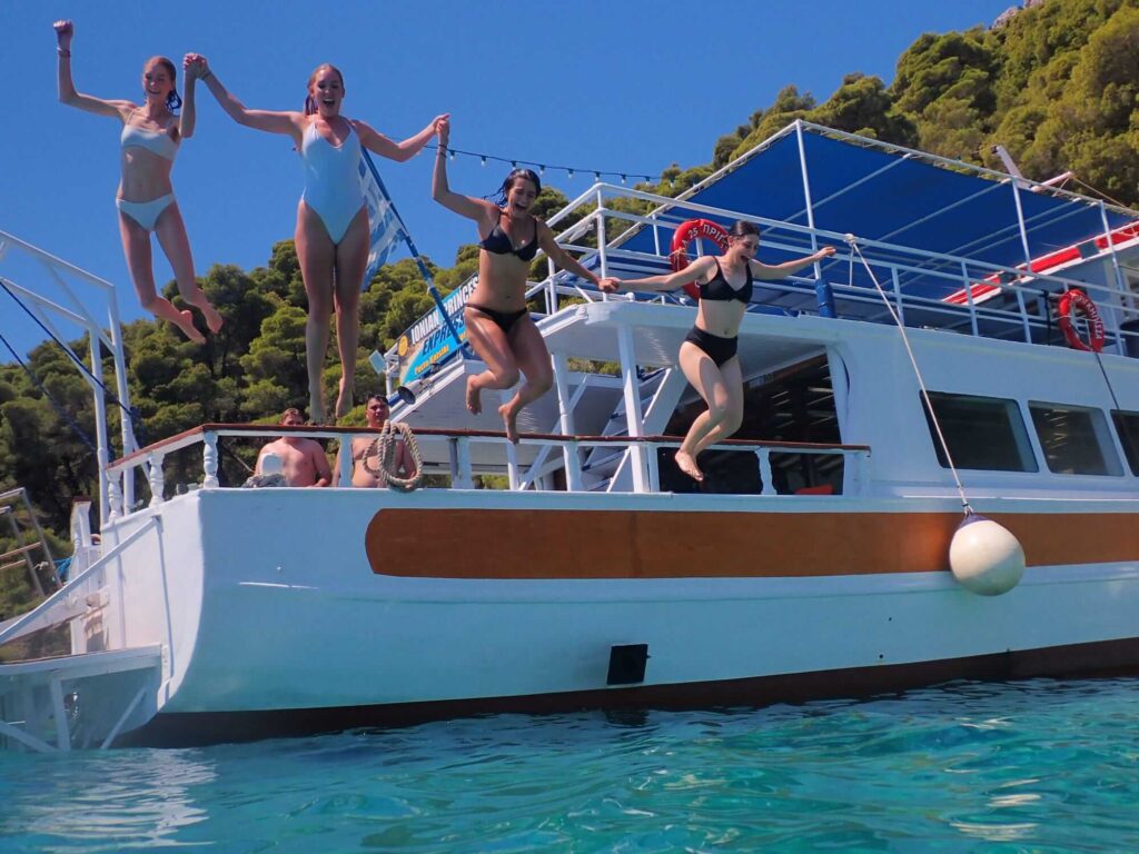 Travellers jumping off a boat on the Topdeck Get Social: Big European trip