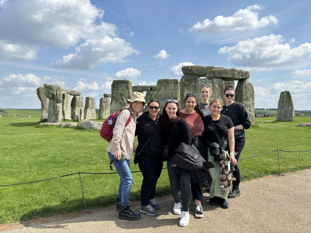 Group of travellers at Stonehenge on the Topdeck Play & Pause: Britain & Ireland trip